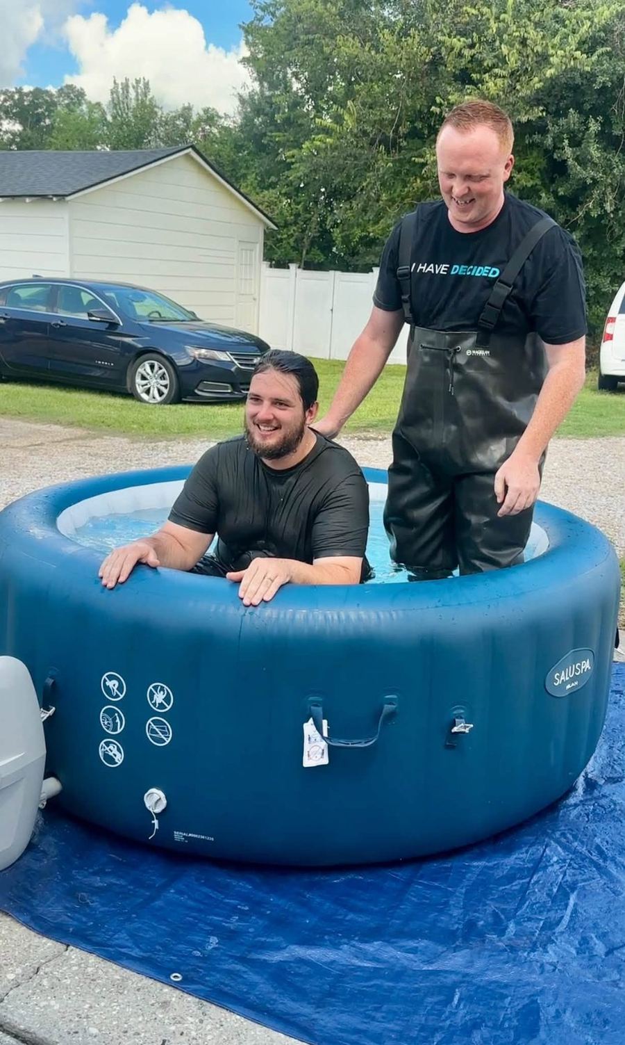 A believer being baptized outdoors