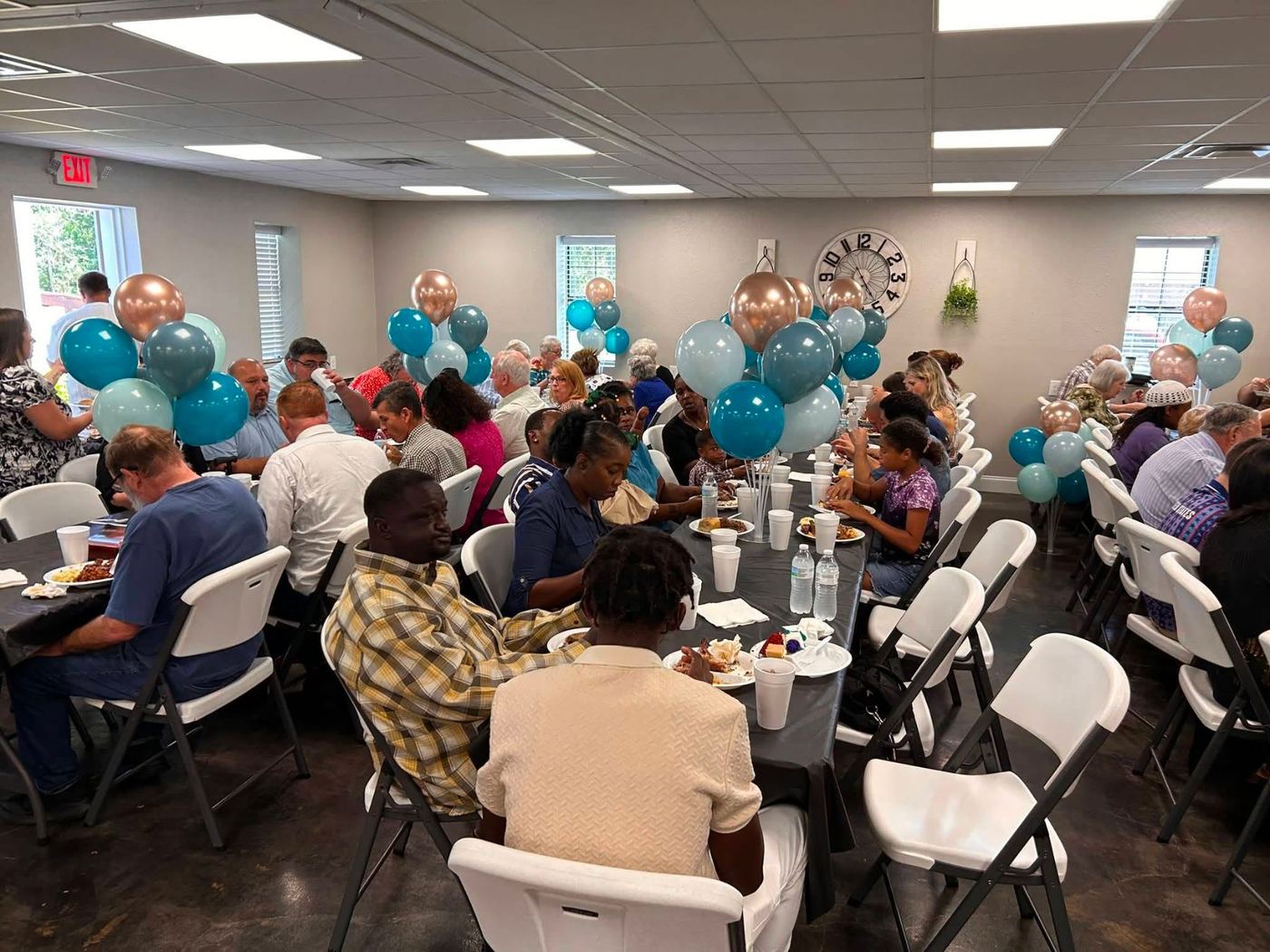 Church family sharing a meal together at a fellowship dinner