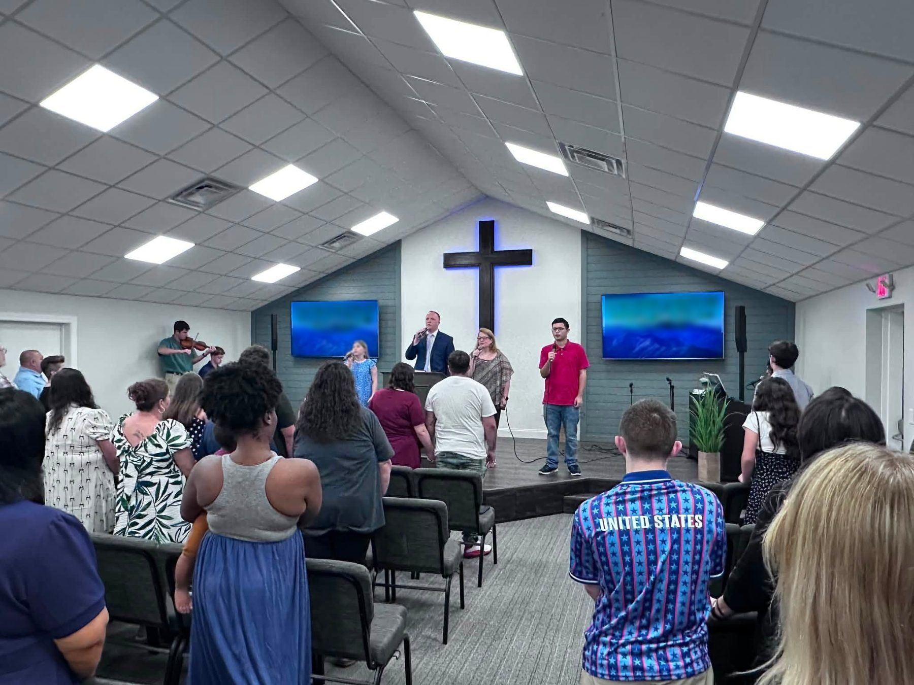 The congregation standing during a Sunday service at Gospel Light